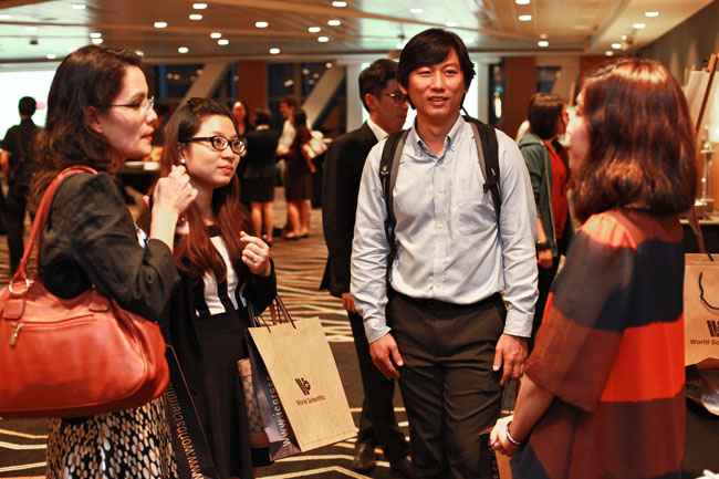 Asian Scientist Magazine marketing manager, Ms. Clara Wong (R), with guests at the party.