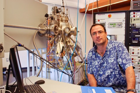 Professor Sowwan sits in front of a nanoparticle deposition system. Credit: OIST.