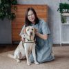 A phot of Dr Tan Hwei Lan with a guide dog